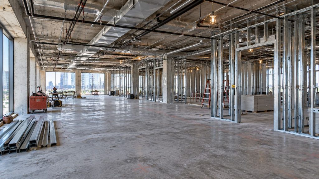 Light-gauge metal stud partitions framed across an open office floor